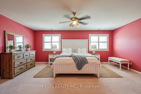Second-floor primary bedroom with an accent wall at 1400 The Esplanade N #411, Pickering, listed by The Gordon Brothers Team, Revel Realty Inc., Brokerage